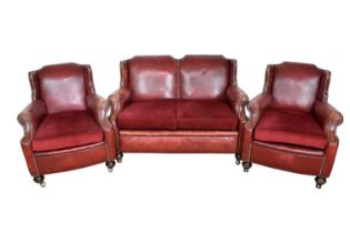 1920s stud closed red leather upholstery three piece suite, each of wing form, raised on bun feet an