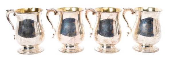 Set of four silver baluster mugs