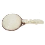 Chinese jade and white metal hand mirror, stamped HK, the oval mirrored plate with convex jade plaqu