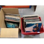 Two boxes containing a selection of LP records and 12 inch singles including Ace of Base, Bob Marley