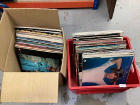 Two boxes containing a selection of LP records and 12 inch singles including Ace of Base, Bob Marley