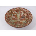 An early antique earthenware or red ware pottery bowl with glazed decoration.