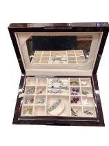 Contemporary jewellery box containing silver brooches, two silver pendant necklaces, silver bangle,