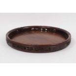 Early 20th century Chinese carved hardwood circular tray with pierced gallery border