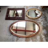 Four various bevelled wall mirrors in frames