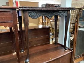 Antique carved mahogany serpentine fronted card table with fold over top on turned legs and pad feet