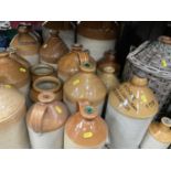 Collection of antique stoneware flagons and bottles to include Colchester and local
