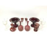 Group of cranberry glass, including a pair of pedestal dishes, together with a set of four wine glas