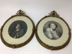 Pair of oval pictures in ornate gilt frames