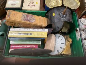 One box containing a collection of assorted clock parts and related reference books.