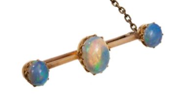 Late Victorian opal bar brooch with three oval opal cabochons in gold claw setting on a knife edge b