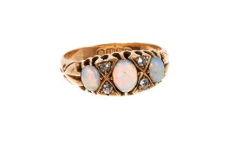 Edwardian opal and diamond ring with three opal cabochons interspaced by four old cut diamonds in ca