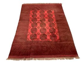Large belouch rug, with three rows of quartered medallions on claret ground, in multiple borders, 26