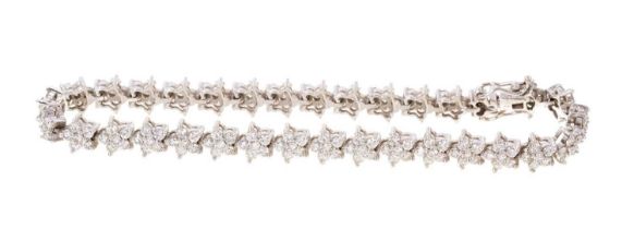 Diamond bracelet consisting of thirty-two flower-head clusters, each cluster comprising six brillian