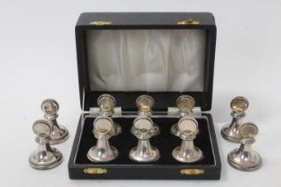 Six silver menu holders in a fitted case, plus four others.