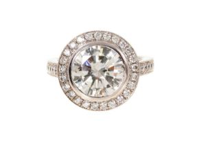 Fine diamond single stone ring, the round brilliant cut diamond weighing 3.38 carats, in a rub-over