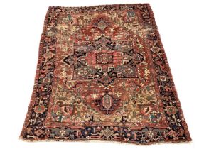 Large Heriz rug, with typical angular vibe ornament on brick red ground, in conforming borders, 320