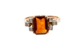 Art Deco-style garnet and diamond ring with a rectangular cut-cornered step cut garnet flanked by si