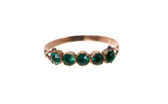 Georgian gold and green paste ring with a band of five green paste stone in gold closed back setting