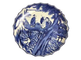 Large Japanese blue and white porcelain charger, circa 1900, painted with a figural scene