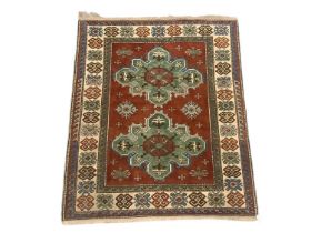 Small Kazak rug, with two cruciform medallions on umber ground in geometric borders, 180 x 150cm