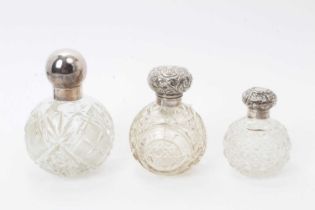 Edwardian silver mounted cut glass scent bottle of globular form and two others