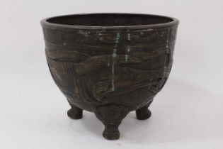 A Japanese bronze footed bowl, decorated in relief with birds, character mark to base, 22.5cm high