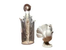 Lladro porcelain figure of a lady wearing a hat, together with a Lladro Dove (2)
