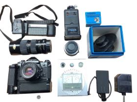 Canon A-1 35mm SLR camera and lens together with a flash and other accessories