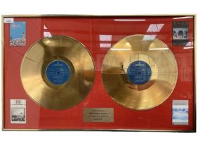 Framed double gold Rush records presented for £500,000 sales