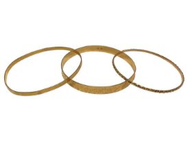 Three yellow metal bangles