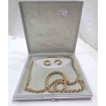 A part suite of Monet gold plated jewellery comprising necklace, bracelet and a pair of earrings -