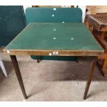 A vintage stained wood card table with baise top, set on folding legs - sold with a modern