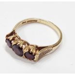 A 375 (9ct.) gold three stone garnet ring - size S
