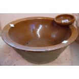 A 19th Century pottery wash bowl with round soap holder to rim, covered in a lead glaze finish