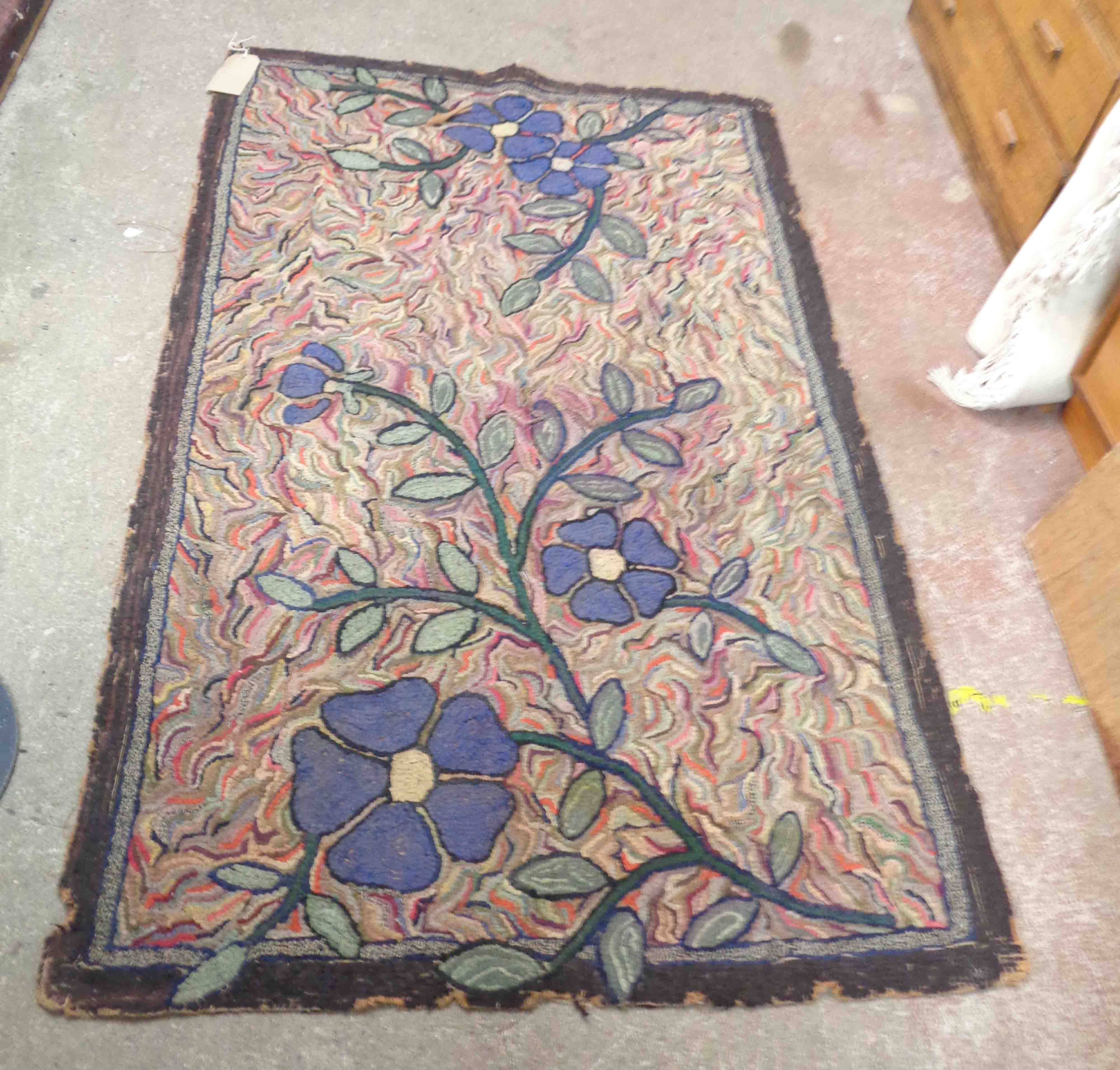 A 1930's Art Deco hand made pulled wool rug with large blue flowers on multi-coloured ground -