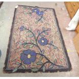 A 1930's Art Deco hand made pulled wool rug with large blue flowers on multi-coloured ground -