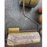 An old granite and wrought iron garden roller