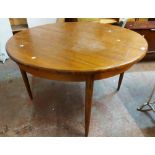A 1.22m diameter G-Plan teak effect extending dining table with stowed folding leaf, set on