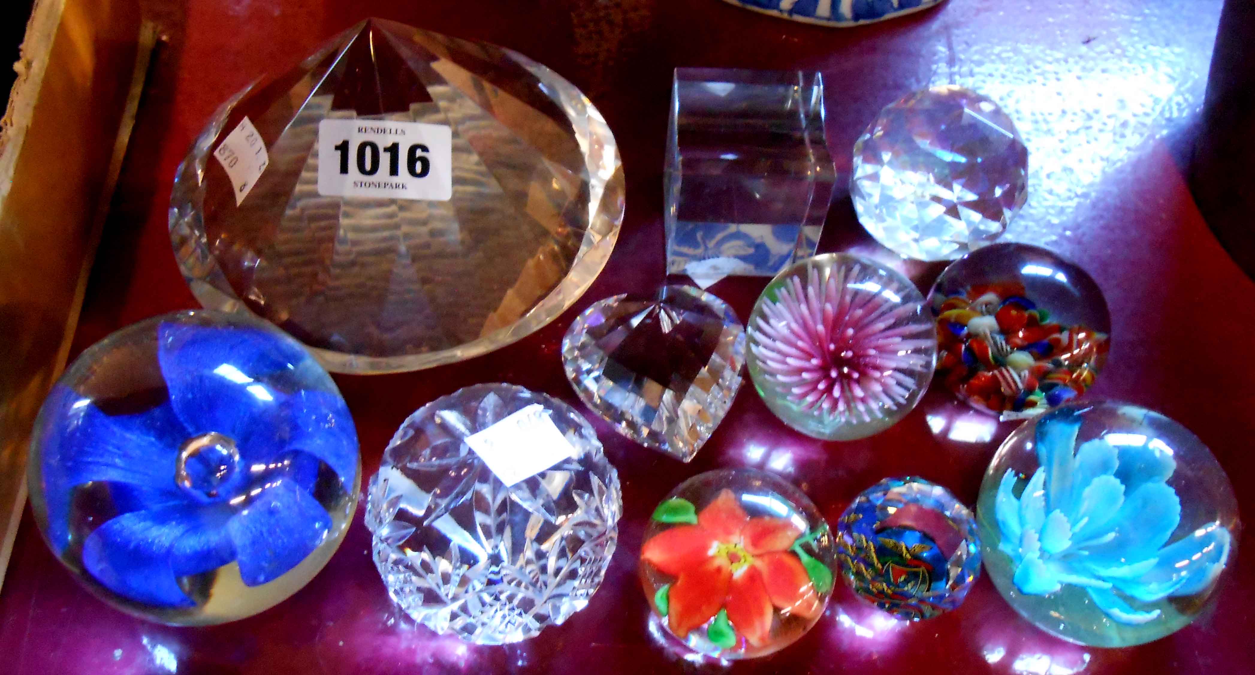 A quantity of glass paperweights - sold with a large crystal 'diamond' on stand