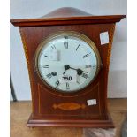 An Edwardian inlaid mahogany cased mantel clock with eight day gong striking movement