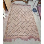 A hand made pulled wool rug with repeat geometric design within a narrow border on brown ground - 2m