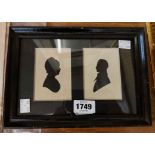 A pair of 19th Century silhouette portraits of a man and woman in one frame