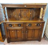 A 1.4m 20th Century polished oak court cupboard in the antique style with canted cupboard and