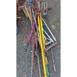 A selection of assorted garden tools including hoes, rakes, forks, etc.