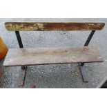 An old cast iron folding bench with woo An old cast iron folding bench with wooden slat back and