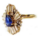 A 750 (18ct.) gold Art Deco style ring, set with central pear cut sapphire within a radial