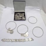 A bag containing a collection of part silver 3d coins and other coin and faux coin set bangles and a
