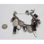 A white metal charm bracelet, set with silver fobs, banded agate charms, drilled silver coins and