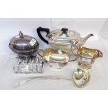 A silver plated three piece tea set - sold with a spoon warmer, large ladle and a toast rack